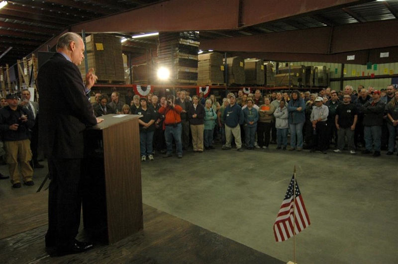 Figure 5 — The Rochester workforce gathered on the factory floor for a visiting speaker in November 2007, in a photograph from the same visit as the barrel-line picture above. The scale of the building is the…