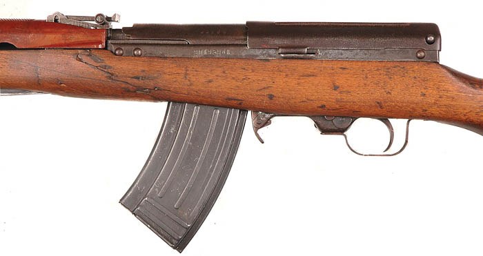 Figure 7 — The left side of a stamped-receiver Type 63, where the serial number is stamped above the magazine well. Rivet heads are visible at both ends of the receiver wall. From Iannamico, Small Arms Review…