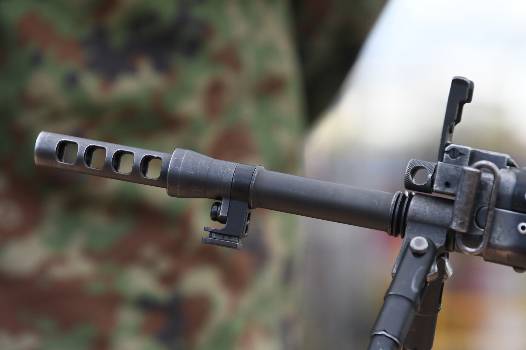 Figure 9 — The muzzle device on a rifle at Camp Yao, October 2023, from the left: four rectangular ports through the side, and behind them the front-sight block and the folded front sight. Photograph by Hunin…
