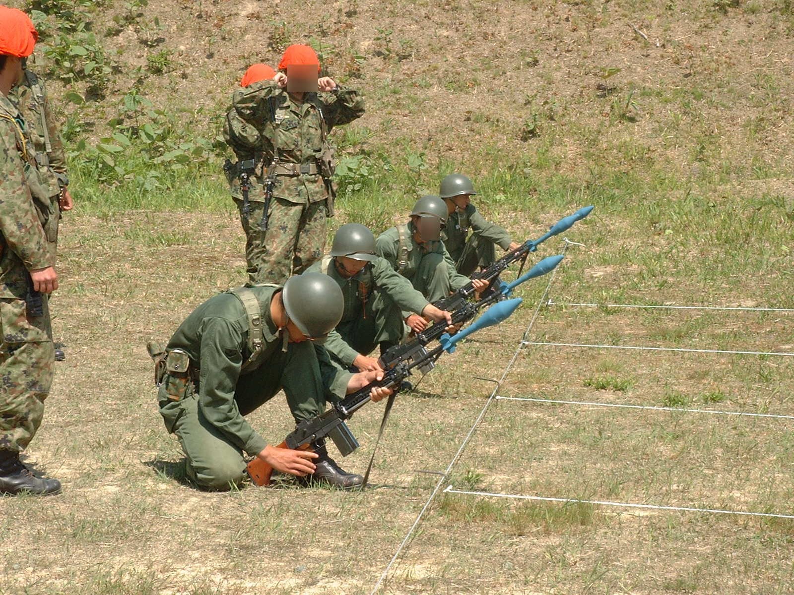 Figure 4 — Soldiers training with M31 rifle grenades fitted to Type 64s, about 2003; the grenades are training rounds. Photograph by Norseman5614, CC BY-SA 3.0, via Wikimedia Commons.