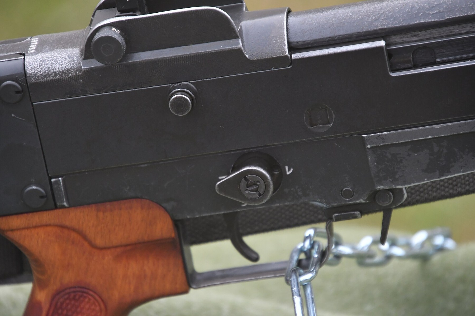 Figure 7 — The selector on the right of the receiver, Camp Uji, November 2022. The lever's tail points to the rear; the mark レ is legible above and forward of the lever's pivot, beside the hole its stud drops…