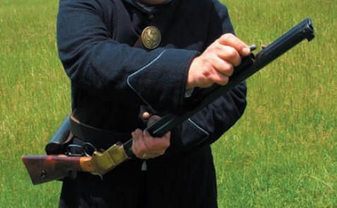Figure 11 — Step 3: the cartridges are dropped in from the muzzle end. Public domain, NPS.