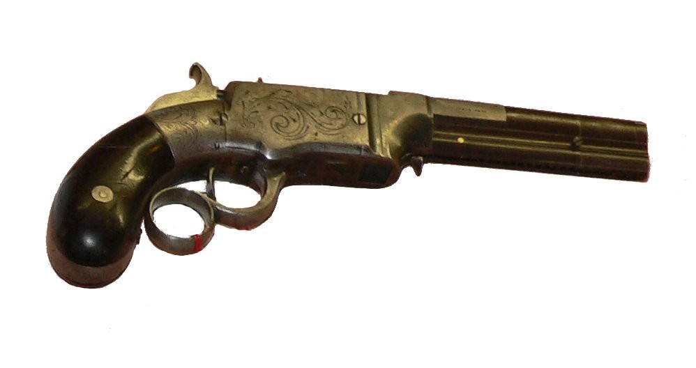 Figure 15 — The pistol in panel B at full size: an engraved brass frame, an octagon barrel, a ring lever and a bag-shaped dark grip. Its photographer labelled it a Smith and Wesson .31 of 1854 to 1855. The gri…