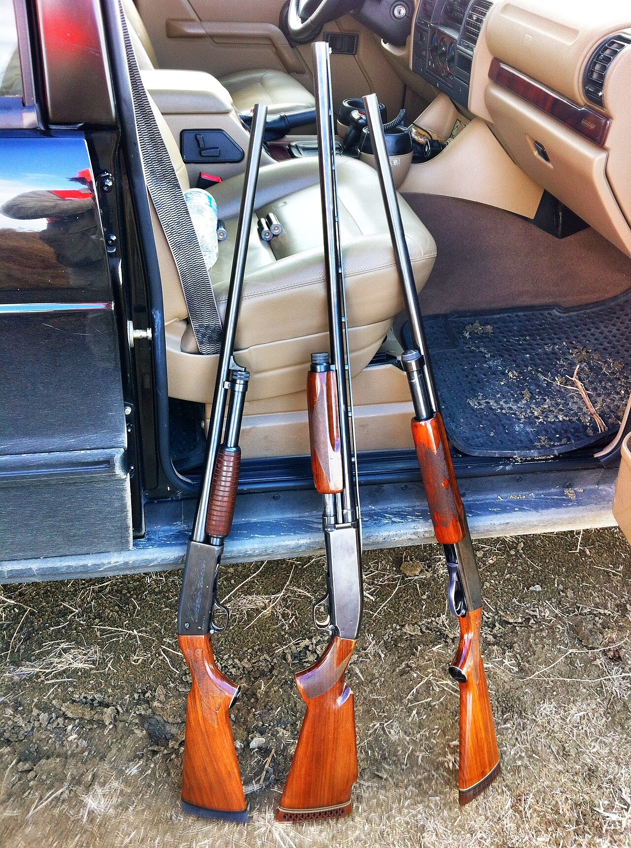 Figure 2 — Three pump guns from the same era of American shotgun design, left to right an Ithaca 37, a Browning BPS Trap and a Remington 870. The Ithaca descends from the same Browning Model 17 design that le…