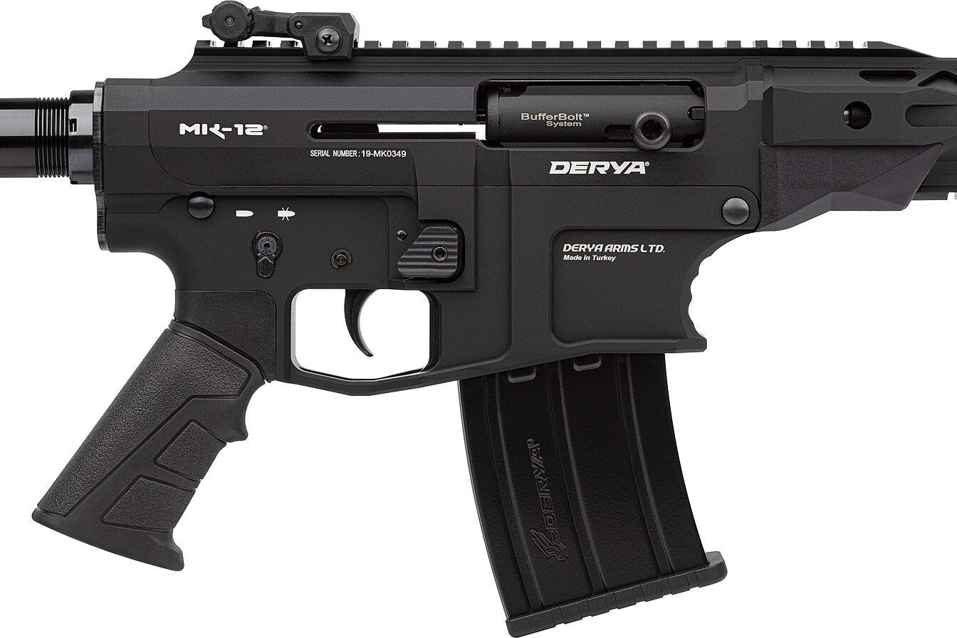 Figure 4 — Close view of the Derya MK-12's receiver, right side: "MK-12" on the upper, the BufferBolt-marked bolt and its round charging knob in the ejection port, the AR-style safety selector with its fire a…