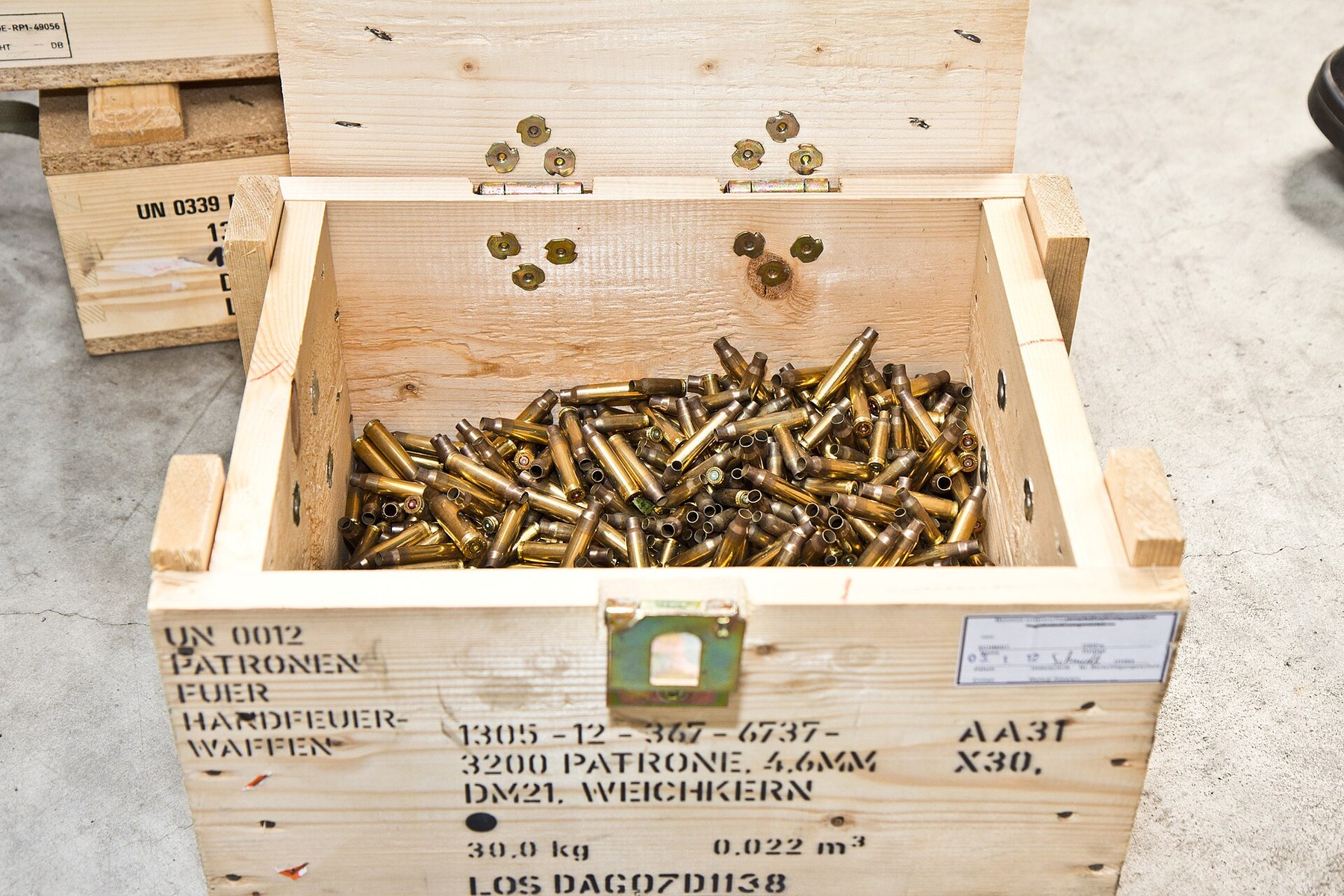 Figure 9 — Fired 4.6×30 cases in an open crate, 2012. The cartridge's small size is apparent against the crate's slats.