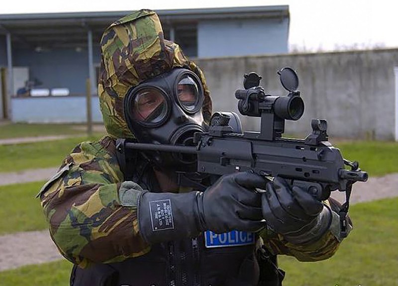 Figure 4 — A Ministry of Defence Police officer in protective equipment on a range with an MP7. The force bought more than 1,500 MP7s in 2005 to a single-shot-only specification; whether a given weapon is tha…