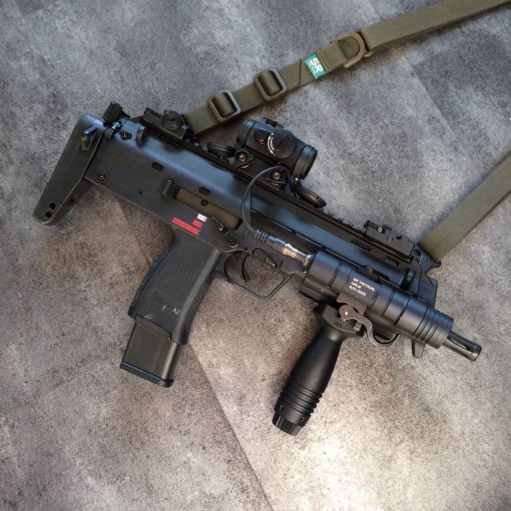 Figure 8 — An MP7A2, as identified by its owner: no folding foregrip, and in its place a rail section under the fore-end carrying H&K's vertical grip, with a weapon light and an Aimpoint Micro sight on a Spuh…