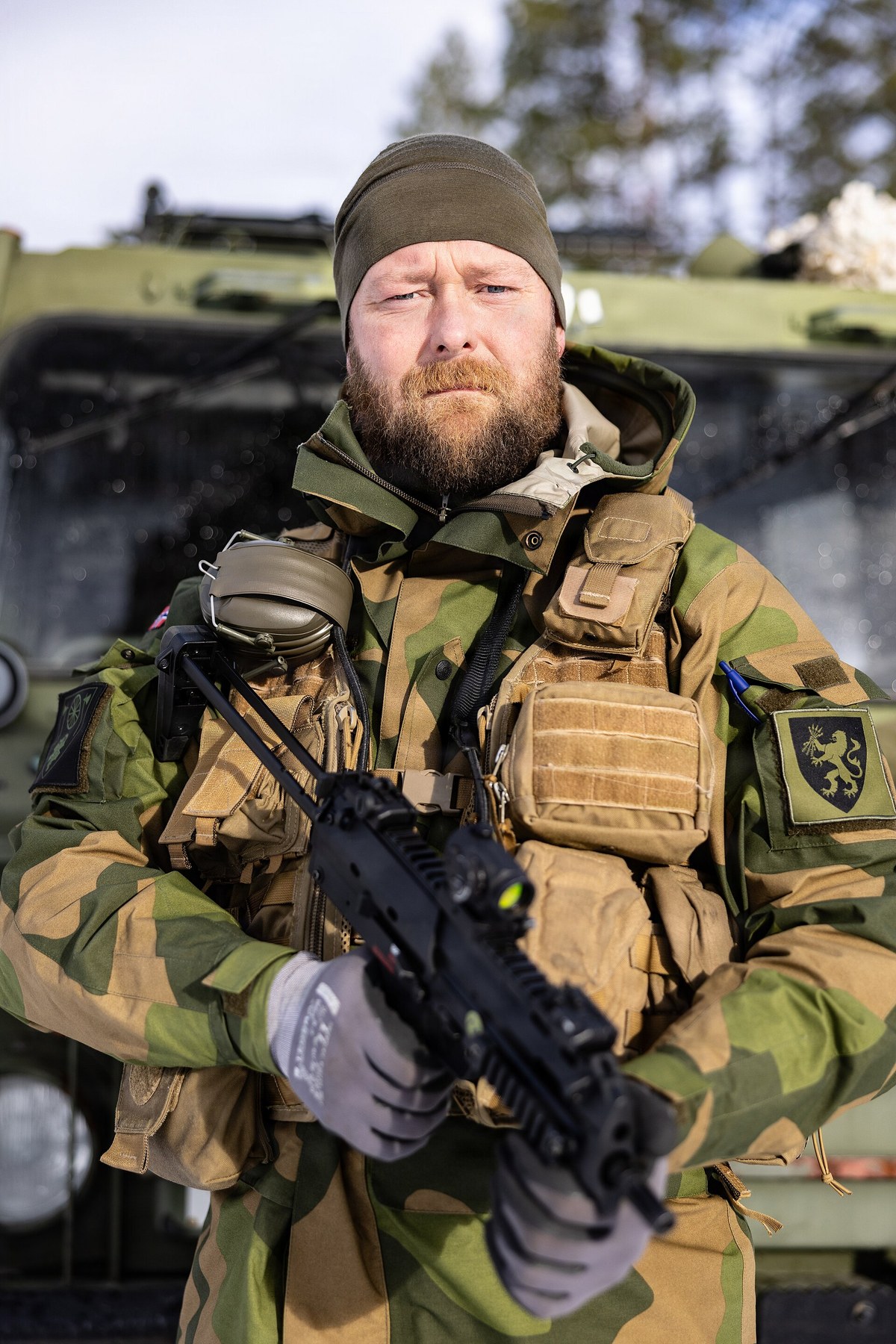 Figure 7 — A Norwegian army corporal, a Bv 206 driver with the Combat Service and Support Battalion of Brigade Nord, at Setermoen during exercise Cold Response 26 in March 2026, with an MP7. A support-unit dr…