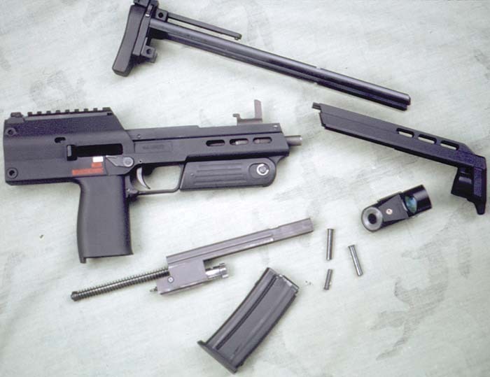 Figure 2 — The PDW prototype field-stripped, from Small Arms Review, April 2001 ("To insure minimal operator maintenance, the PDW is simple to disassemble for cleaning"): the receiver with grip and barrel, th…