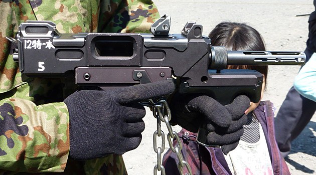 Figure 5 — The right side of an M9 at closer range, with a unit tag on the receiver. Photograph by Argonaut, from Spear Head No. 13 (2012), as reproduced by Hyper Douraku.