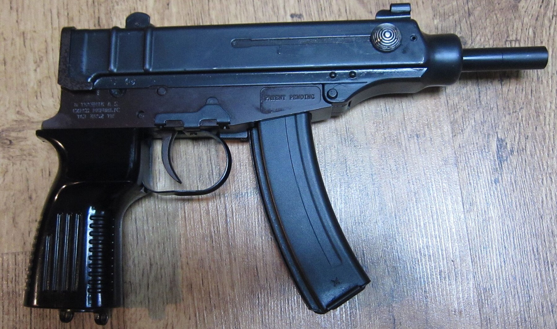 Figure 8 — A semi-automatic D-Technik Škorpion pistol, right side, without a stock: the receiver marked D-TECHNIK a.s. CZECH REPUBLIC and, on a panel, PATENT PENDING. Photograph by Surv1v4l1st, CC BY-SA 4.0, …