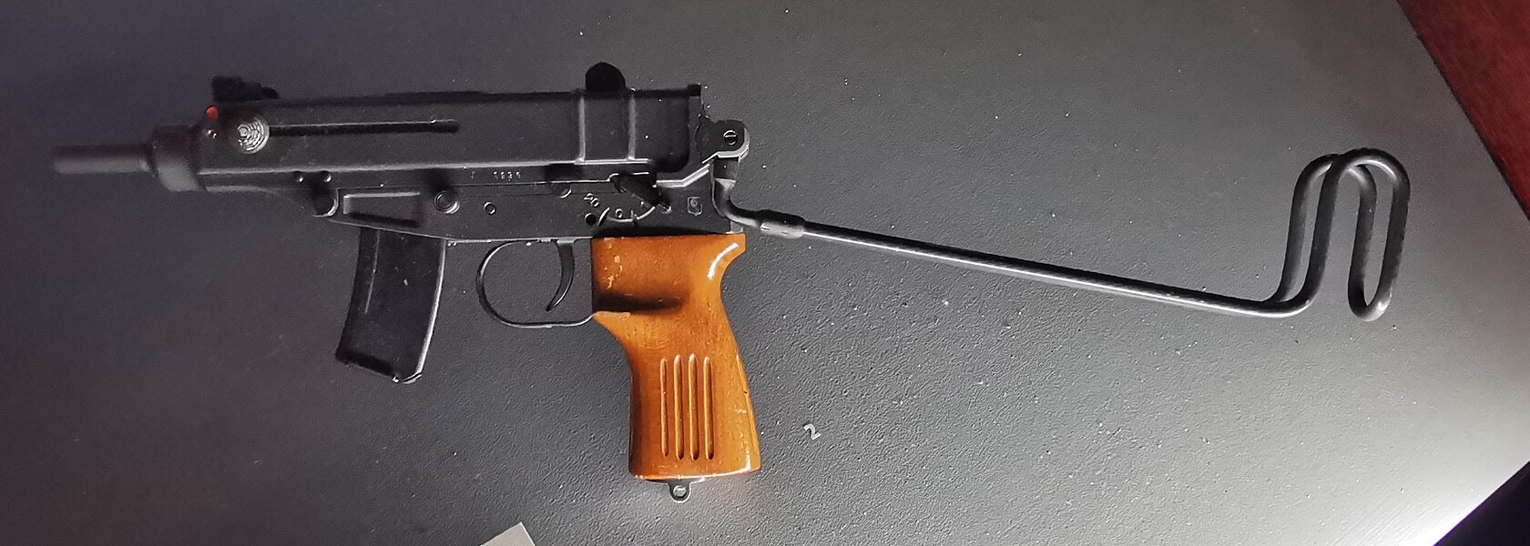 Figure 1 — A vz. 61 with wooden grip, stock unfolded and 10-round magazine, left side, in the permanent exhibition of the Prague Castle Guard in the Powder Tower (Mihulka), Prague Castle, 2024. Photograph by …