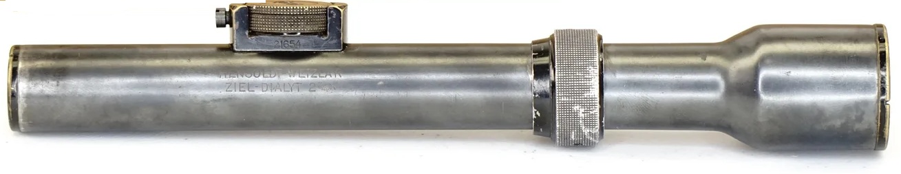 Figure 7.1 — A real Hensoldt-Wetzlar Ziel-Dialyt 3× scope (S/N 21654, visible on the windage drum), the canonical DL-44 scope. The "HENSOLDT WETZLAR" and "ZIEL DIALYT" markings are clearly engraved…