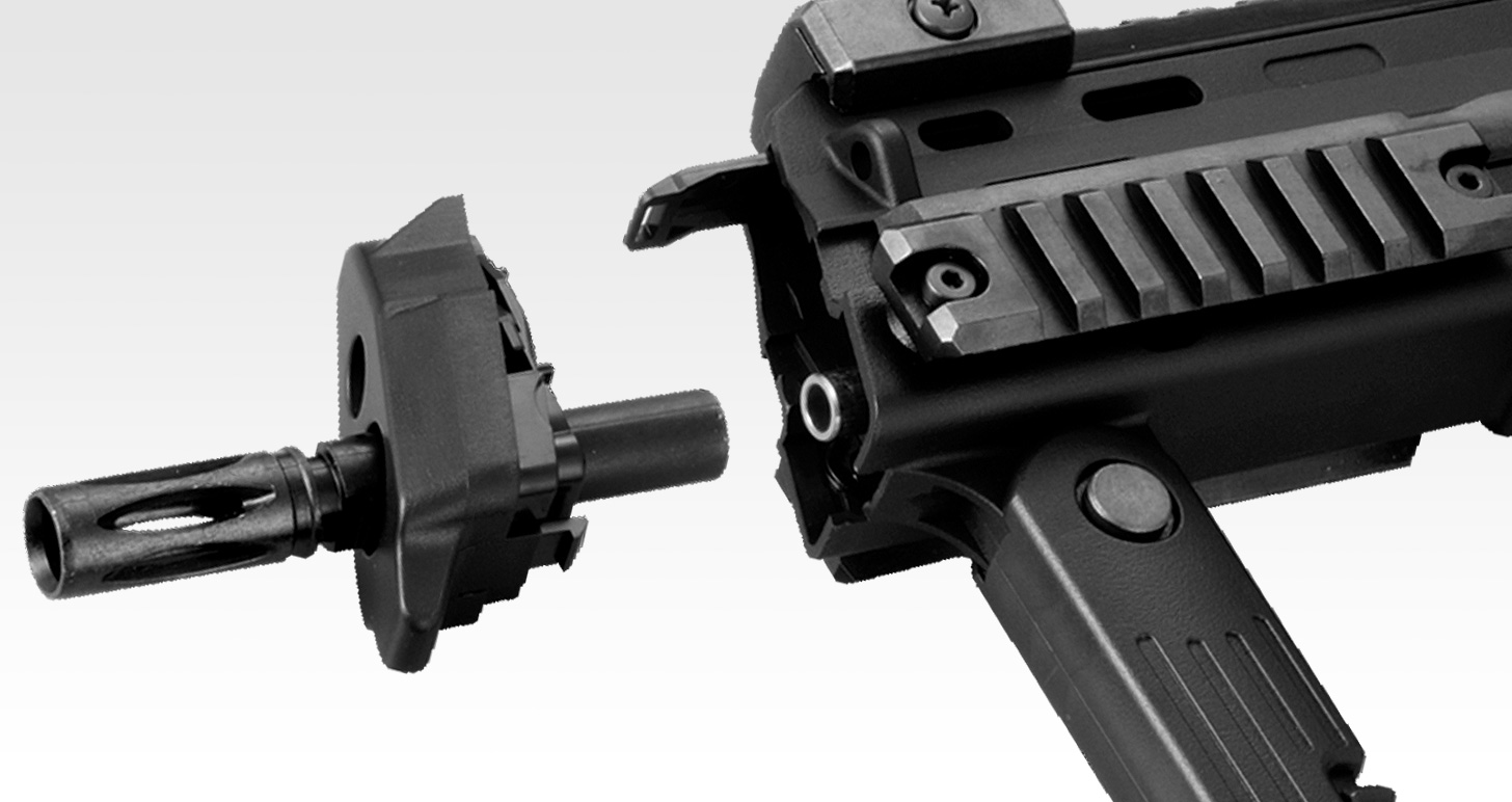Figure 4 — Tokyo Marui's photograph of its electric MP7A1 with the front cap and flash hider removed together. Behind the cap is the front of the receiver; the battery bay on the electric guns is reached from…