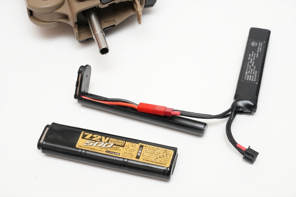 Figure 6 — The Tokyo Marui micro battery and a LiPo adapter used in the same owner's gun. The battery is a 7.2 V NiMH stick small enough to fit the front bay. Photo: ASCII (Weekly ASCII), April 2023.