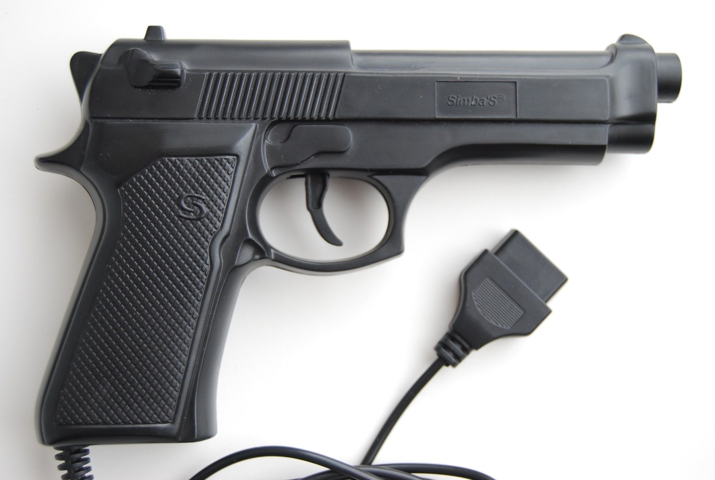 Figure 7 — A light gun sold by Simba for the Dendy, a Russian-market Famicom clone. Clone guns for Famicom-compatible consoles were usually moulded as realistic semi-automatic pistols and plugged into the clo…
