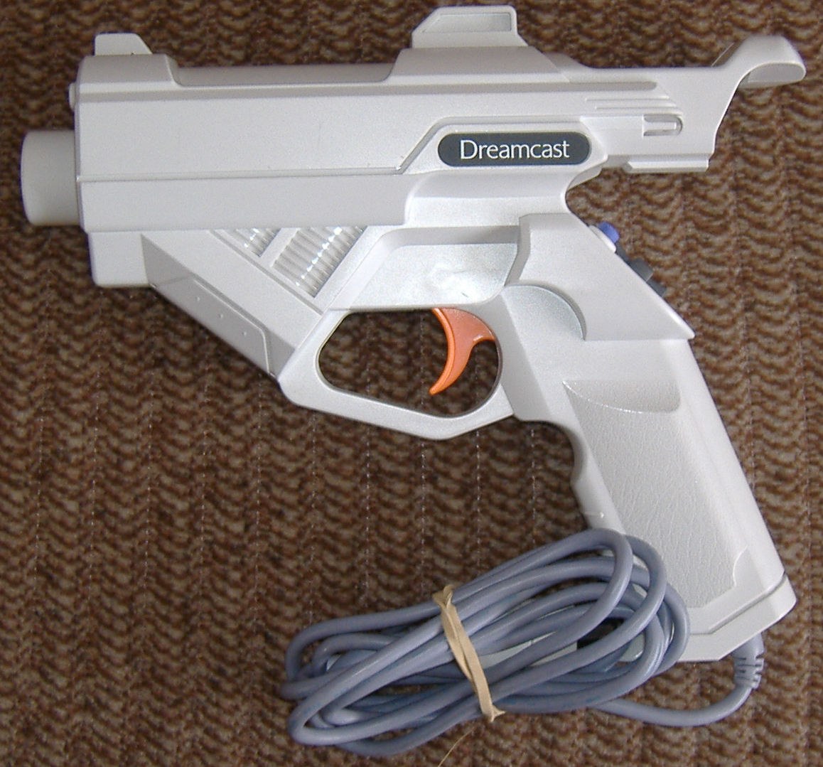 Figure 2 — A second Dreamcast Gun, photographed by its owner. The moulding, the Dreamcast logo on the side of the barrel and the orange trigger are the tells against the third-party guns below, none of which …