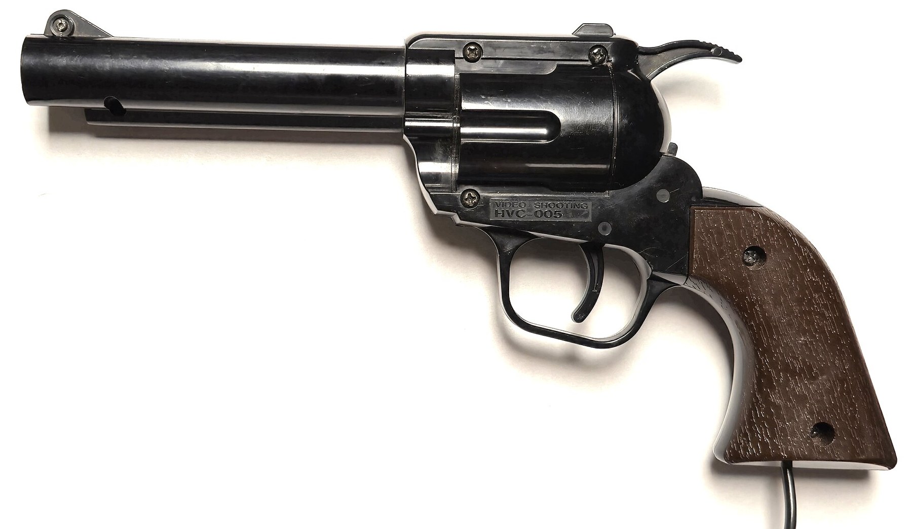 Figure 4 — Nintendo's light gun for the Famicom, sold in Japan as part of the Kōsenjū ("light-ray gun") series: a realistic black revolver with a brown grip. The Victoria and Albert Museum's catalogue entry f…