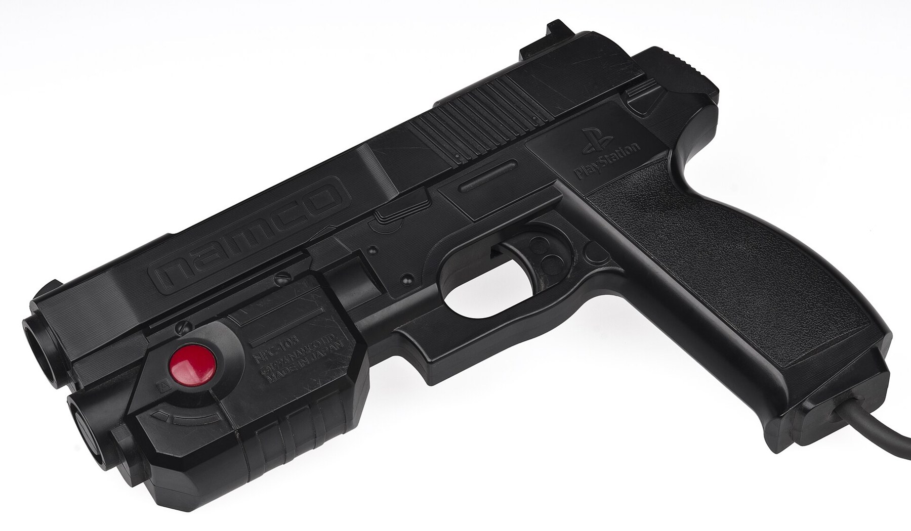 Figure 3 — The original Namco GunCon for the PlayStation: a black pistol with a red-ringed button on the side. In Europe the same gun was sold as the G-Con 45. Its accuracy came from the second cable that ran…