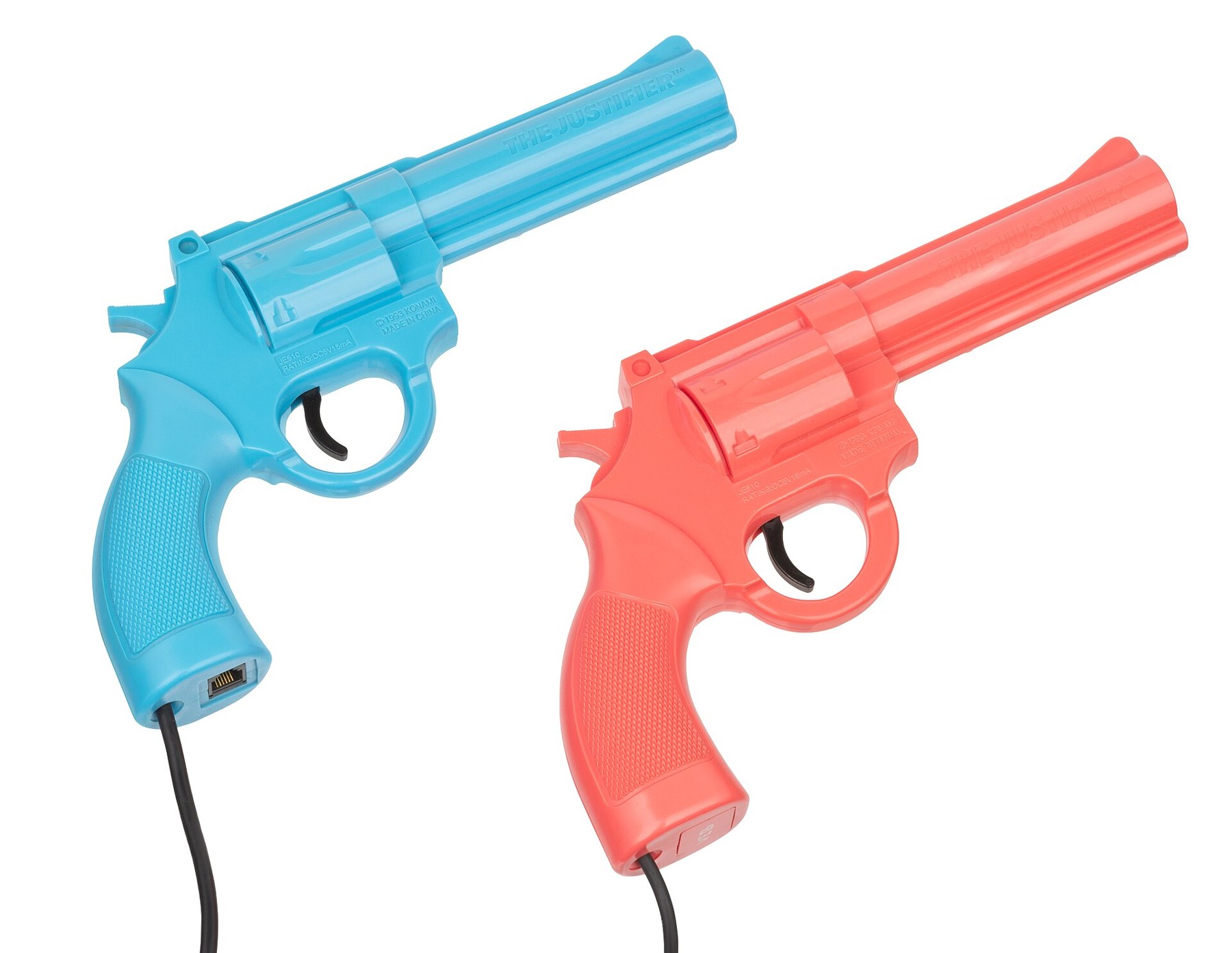Figure 7 — The Konami Justifier pair for the Mega Drive: the blue player-1 gun, which plugs into the console, and the pink player-2 gun, which plugs into the blue one. Both are moulded as revolvers in bright …
