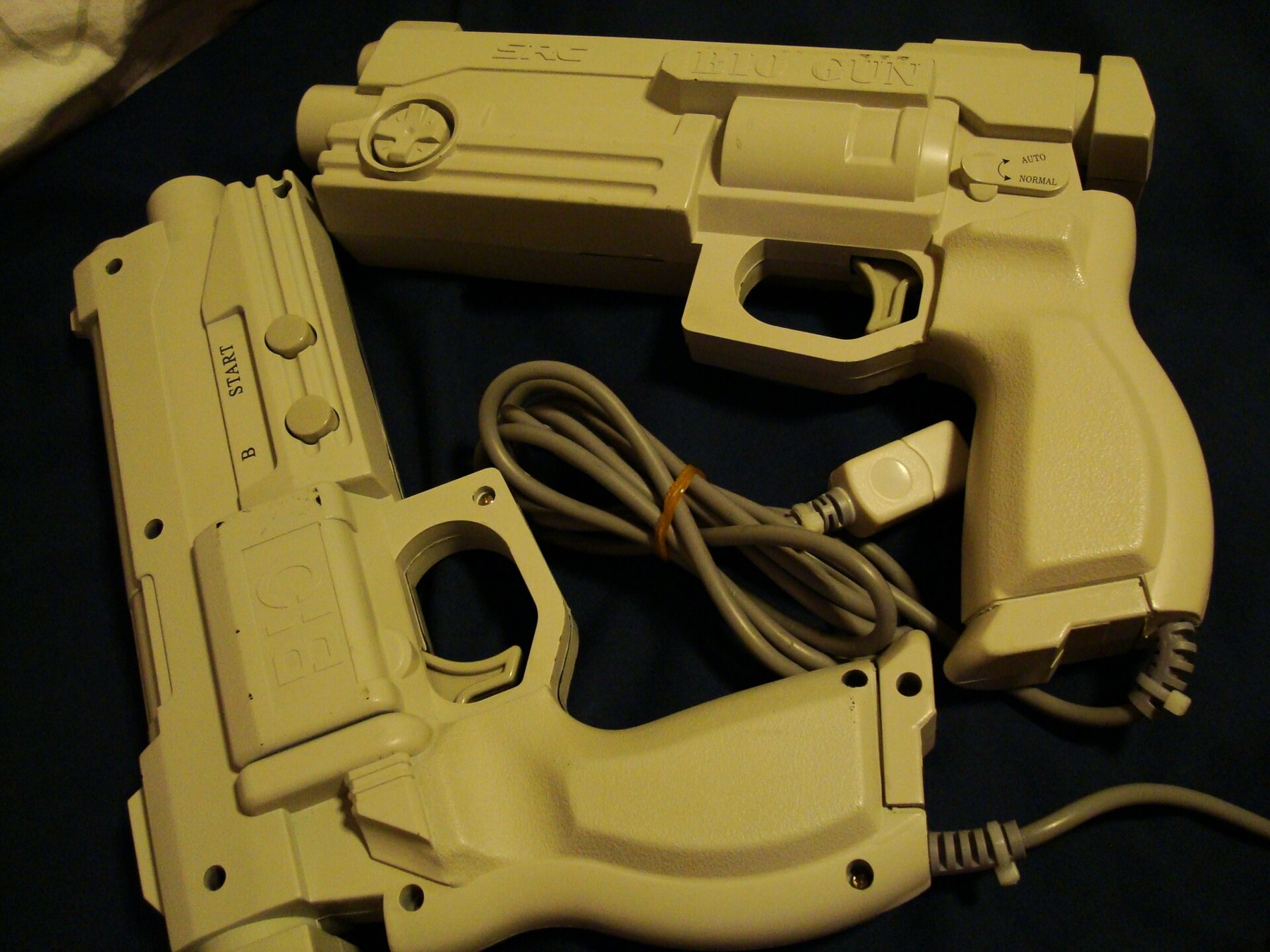 Figure 4 — The SRC Bio Gun, a third-party Dreamcast gun with built-in vibration, in two examples photographed by their owner. Photo: KinkyM3, English Wikipedia, CC BY-SA 3.0.