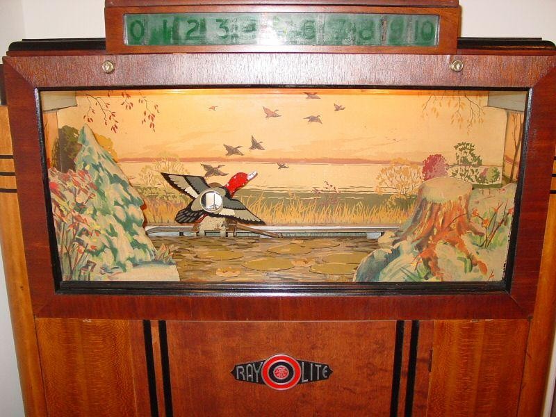 Figure 4 — A surviving Seeburg Ray-O-Lite. The single duck crosses a painted marsh behind the glass; the score reads out in the lamp panel above. Photo: pinrepair.com (Cliff Dennison's arcade restoration page…