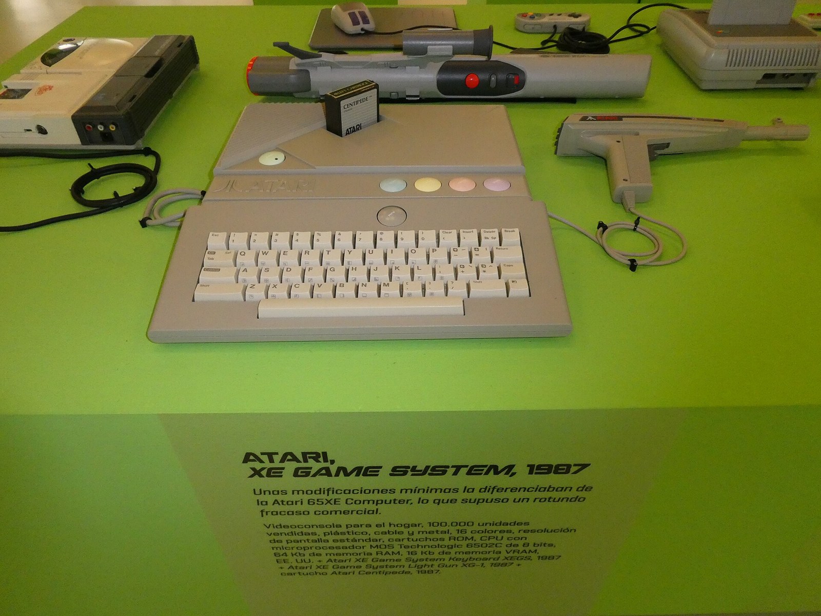 Figure 1 — The Atari XE Game System of 1987 on display with its detachable keyboard, a joystick, cartridges and the XG-1 light gun lying beside the console. The XEGS is an Atari 8-bit computer in a console ca…