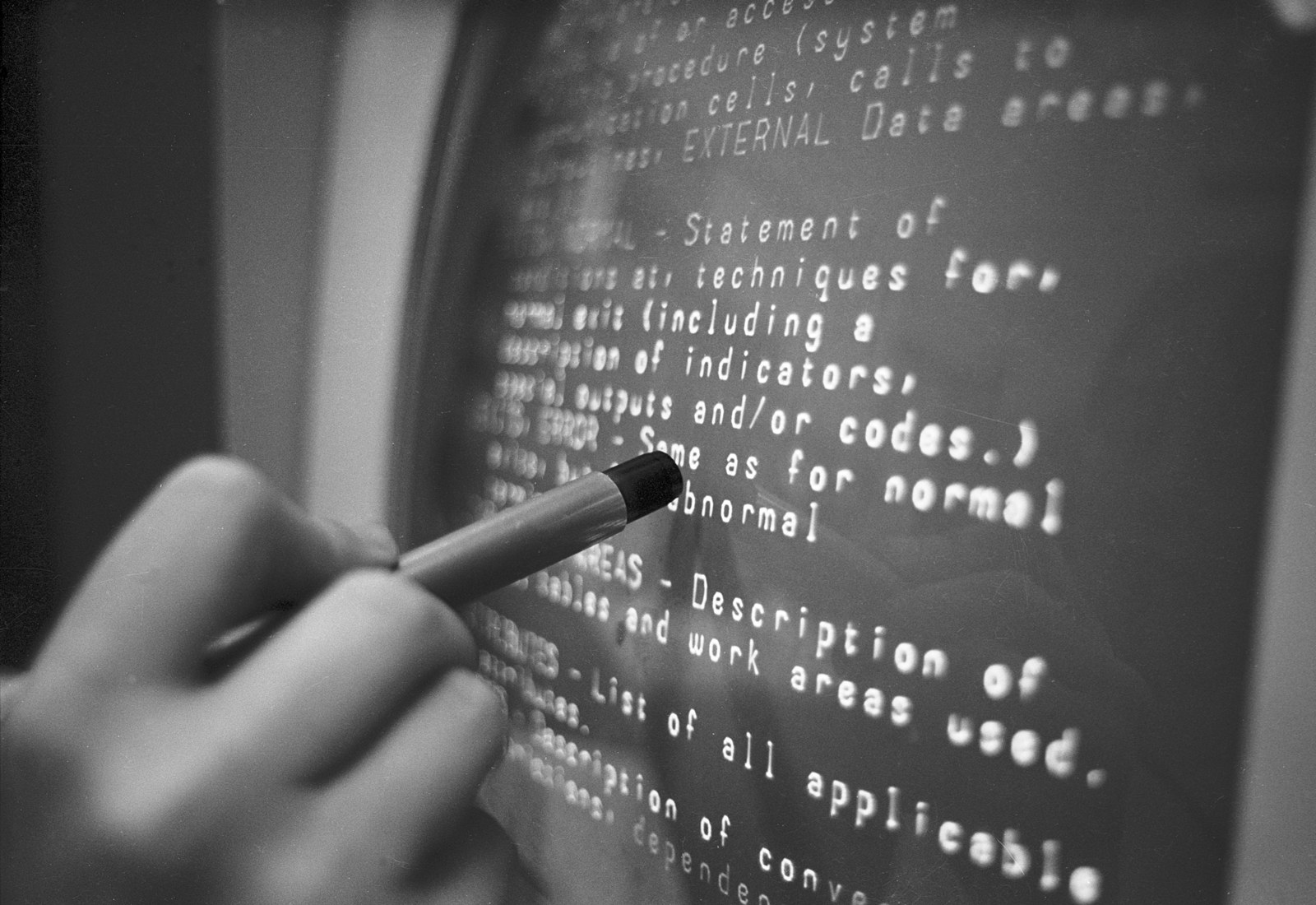 Figure 5 — A light pen in use at an IBM 2250 graphics console, Brown University Hypertext Editing System, October 1969. The pen is held against the face of the vector display, pointing at a line of text. Phot…