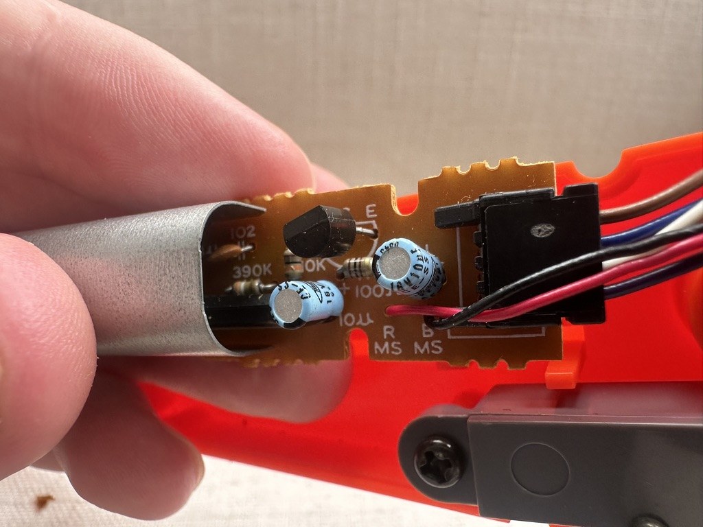 Figure 5 — The Zapper's sensor board half out of the barrel: a transistor, electrolytic capacitors, resistors and the wiring to the cable, with the shielded sensor section at left. Photo: Stay Caffeinated, 26…