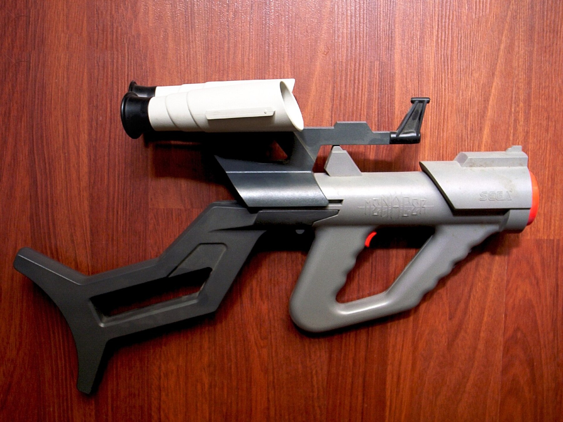 Figure 4 — The Sega Menacer, the Genesis's wireless light gun, with its shoulder stock and the scope on top. Its light sensor was in the gun and its result crossed the room by infrared to a receiver at the co…