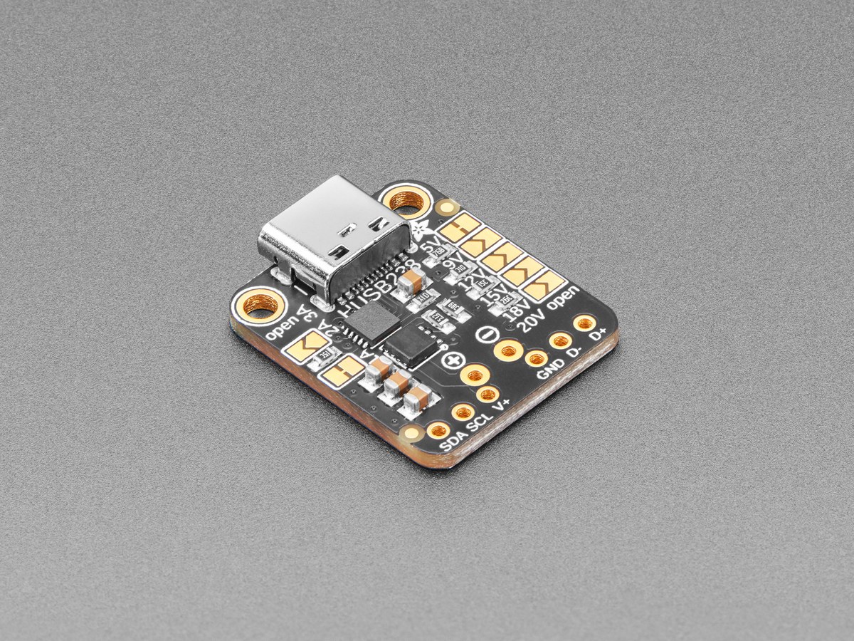 Figure 2 — Adafruit product 5807. The USB-C receptacle and the HUSB238 sit at the top; the solder jumpers on the right choose 5, 9, 12, 15, 18 or 20 V, and those on the left the current; the output is on the …
