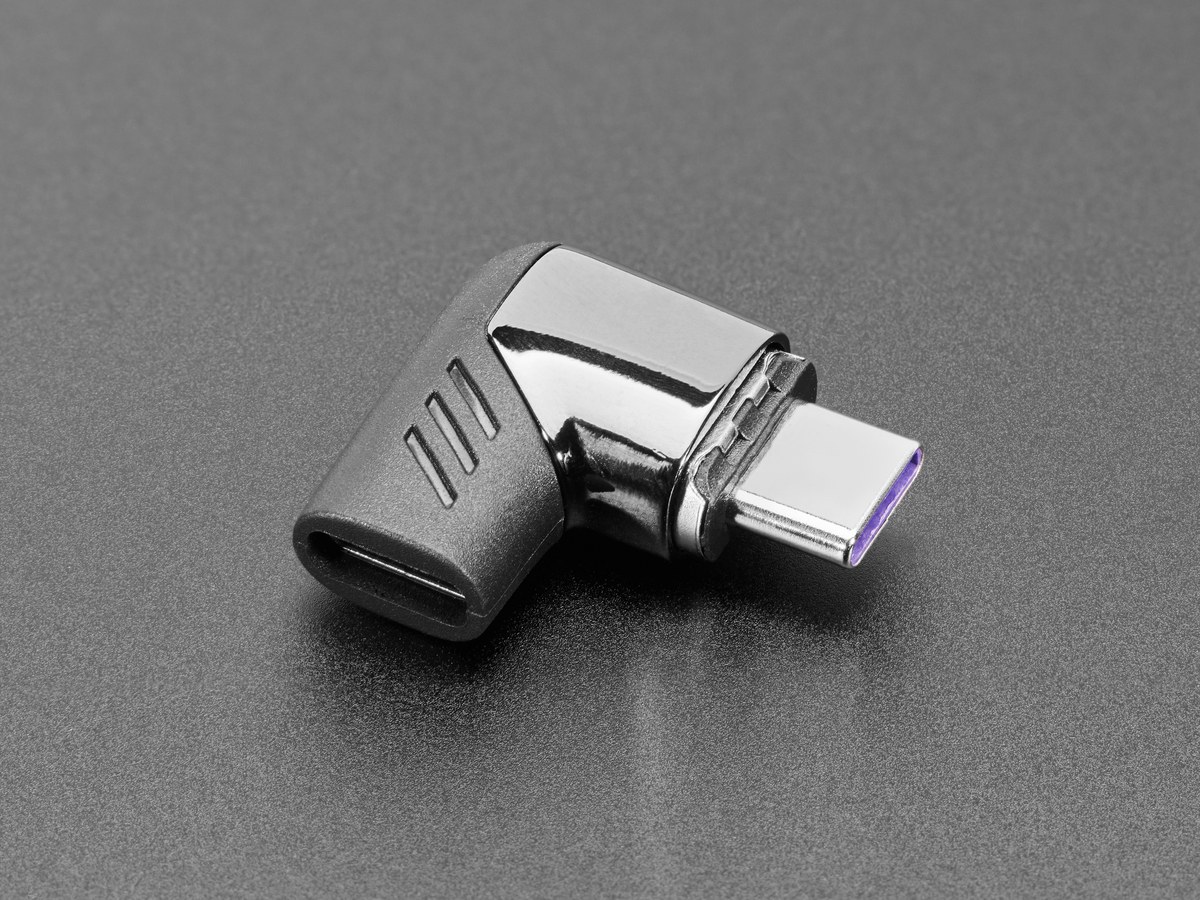 Figure 5 — Adafruit's magnetic right-angle USB-C adapter: a passive adapter whose magnetic nub stays in the device's port while the cable side pulls away. Adafruit gives it "120W" and confirms it passes data,…