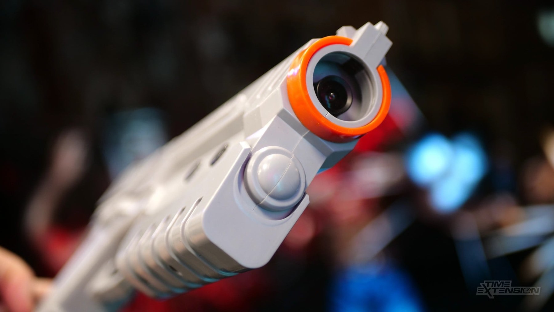 Figure 2 — The muzzle of a Sinden Lightgun. The lens behind the orange ring is the whole sensor: a small colour camera module looking along the barrel. Photo: Damien McFerran, Time Extension.