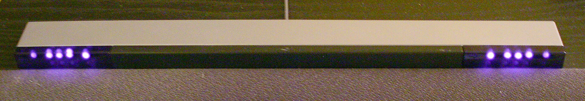 Figure 1 — A Wii Sensor Bar switched on, photographed with a camera that records some near infrared. Each end carries five LEDs; WiiBrew records that the outermost are angled slightly outward and the innermos…