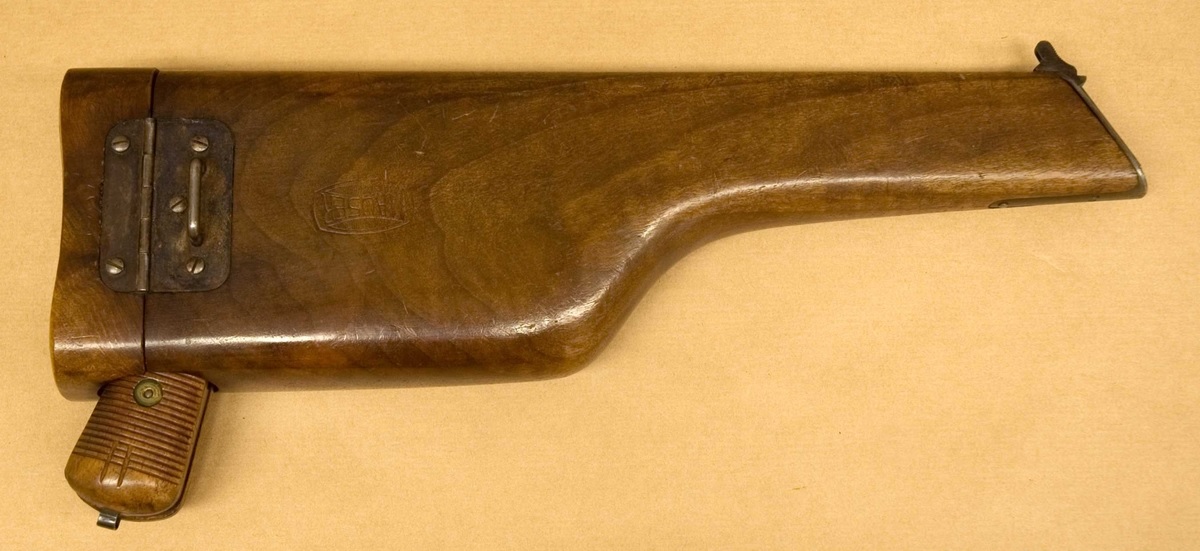Figure 5 — 5 — A Mauser C96 stored in its wooden case-buttstock (Swedish Army Museum collection, donated by collector Gösta Benckert). The wooden case attaches to the rear of the grip frame via a met…