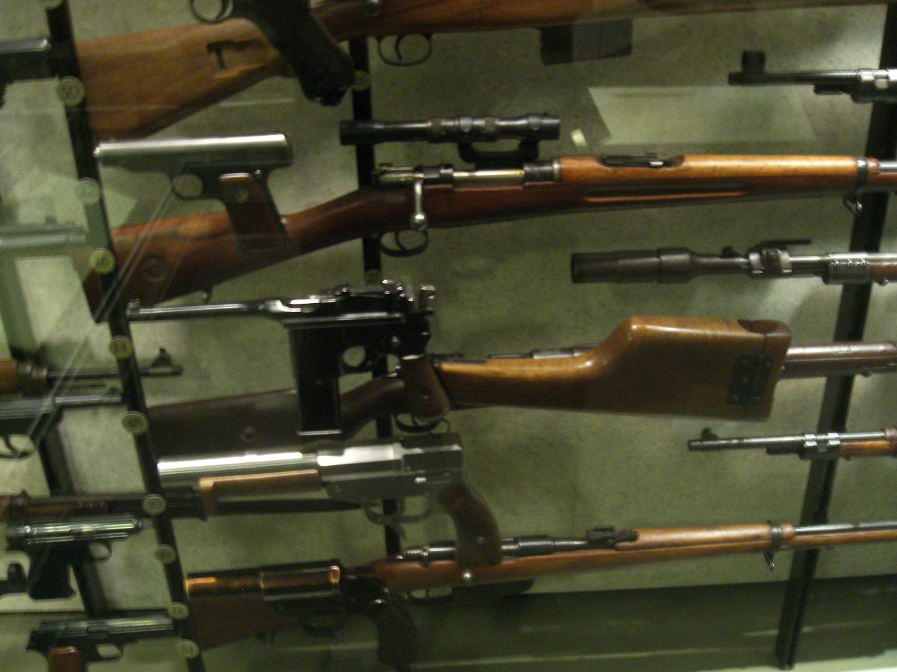 Figure 4 — 4 — Mauser C96 M712 "Schnellfeuer" (selective-fire variant, ~98,000 produced 1932-1937), shown with the wooden shoulder-stock holster attached. The detachable 20-round box magazine and fir…