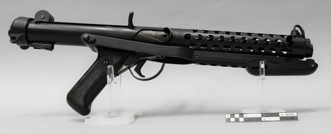 Figure 2 — 4 — A 9 mm L2A3 Sterling with the folding stock stowed under the receiver (NHHC museum specimen, S/N UF57A5347 — note that the serial-number prefix UF indicates ROF Fazakerley production r…
