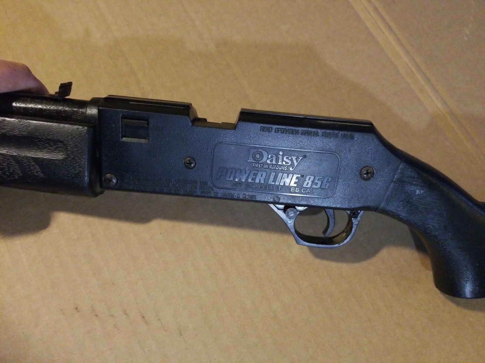 Figure 2 — The left receiver of a Powerline 856, the moulded rollmark reading "POWER LINE 856" over ".177 CAL PELLET BB CAL". That second line settles the question the slot was asking: this example is the du…