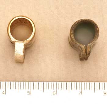 Figure 7 — The Beeman rifle's middle thimble (right), simply rolled from flat brass sheet, beside an unfinished thimble of the original cast pattern made by Cowan for a museum copy (left). Beeman reads the ro…