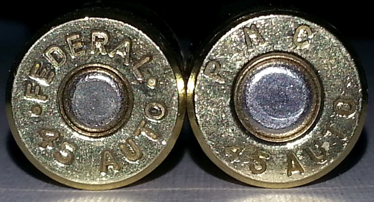 Figure 6 — Two .45 ACP cases photographed side by side. They carry different primer sizes — and the source page states only that the two differ, without identifying which is which. That is not an omission wor…