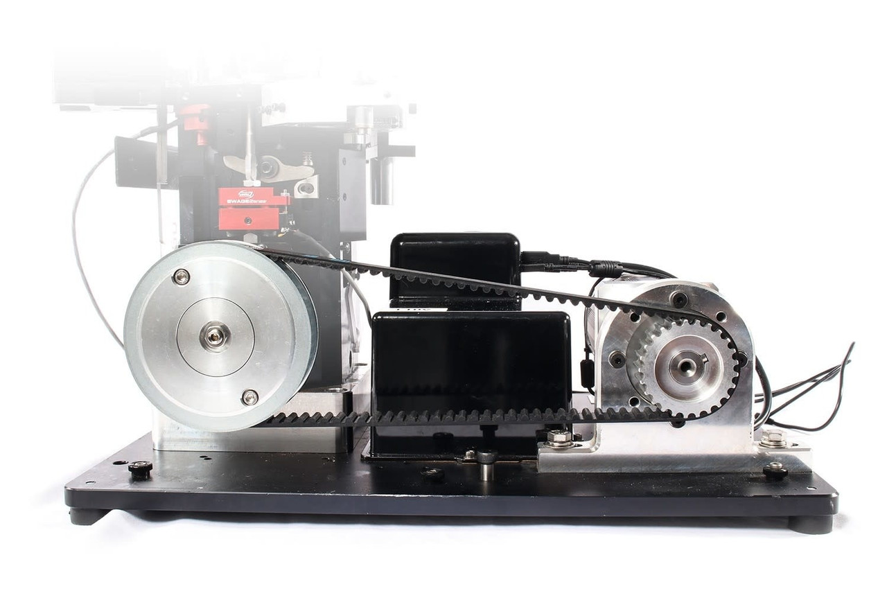 Figure 1 — An autodrive unit on its base plate, with the belt to the crank and the control head visible. It is photographed as a unit rather than fitted to a press, so nothing here shows how it sits on a mach…
