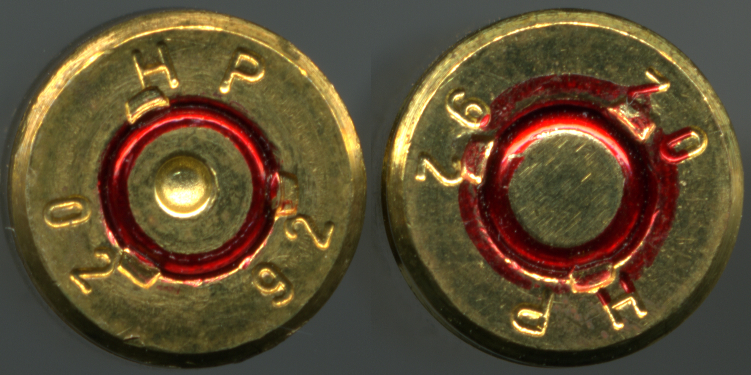 Figure 3 — Two 5.56 case heads: fired on the left, unfired on the right, with the red military primer annulus visible on both. A normal fired head, for calibration, before any abnormal one is described. Photo…