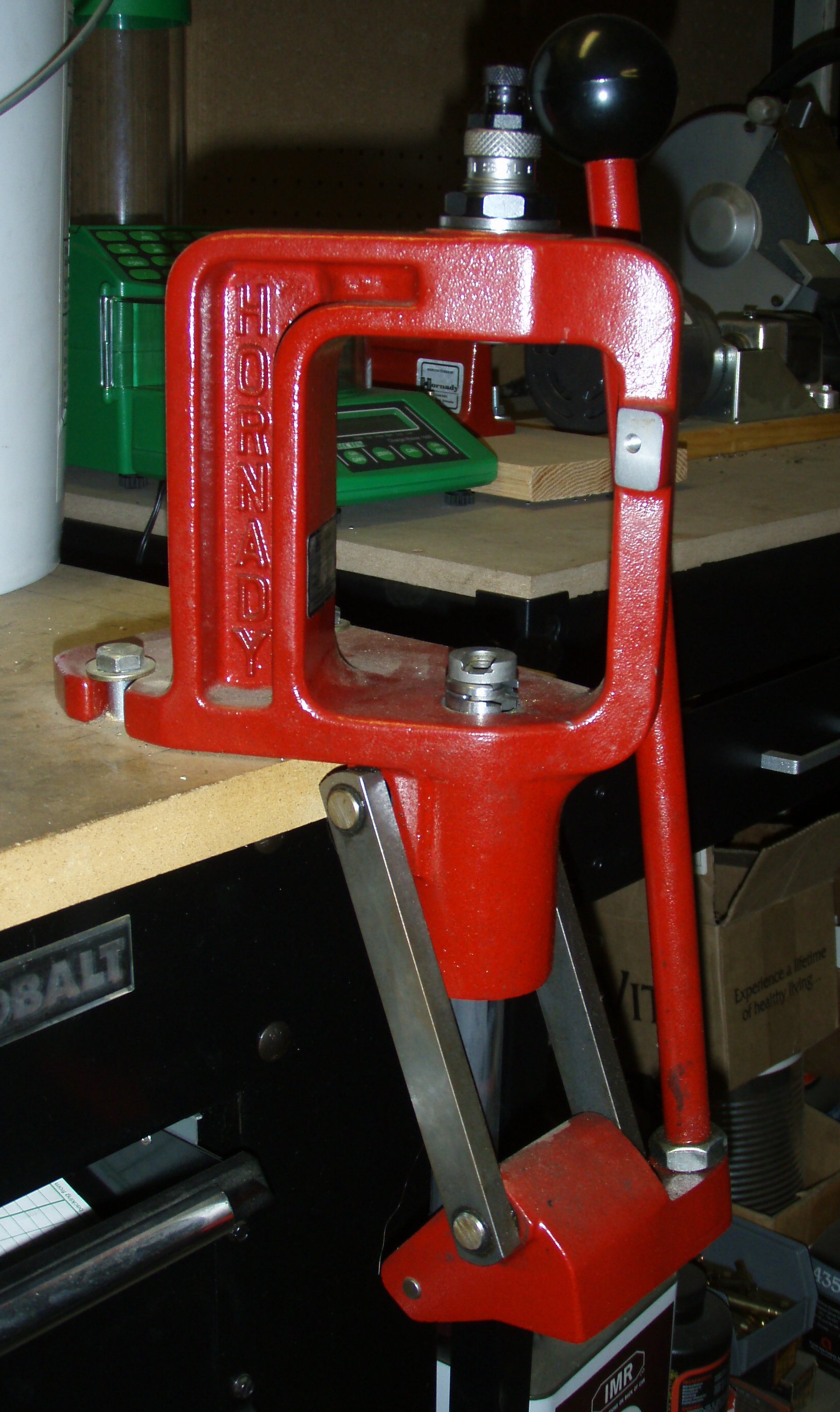 Figure 5 — A Hornady reloading press on the bench. The source page confirms the maker but not the model, so this is a Hornady press and nothing more specific. Photograph by Arthurrh, CC BY-SA 3.0, via Wikimed…